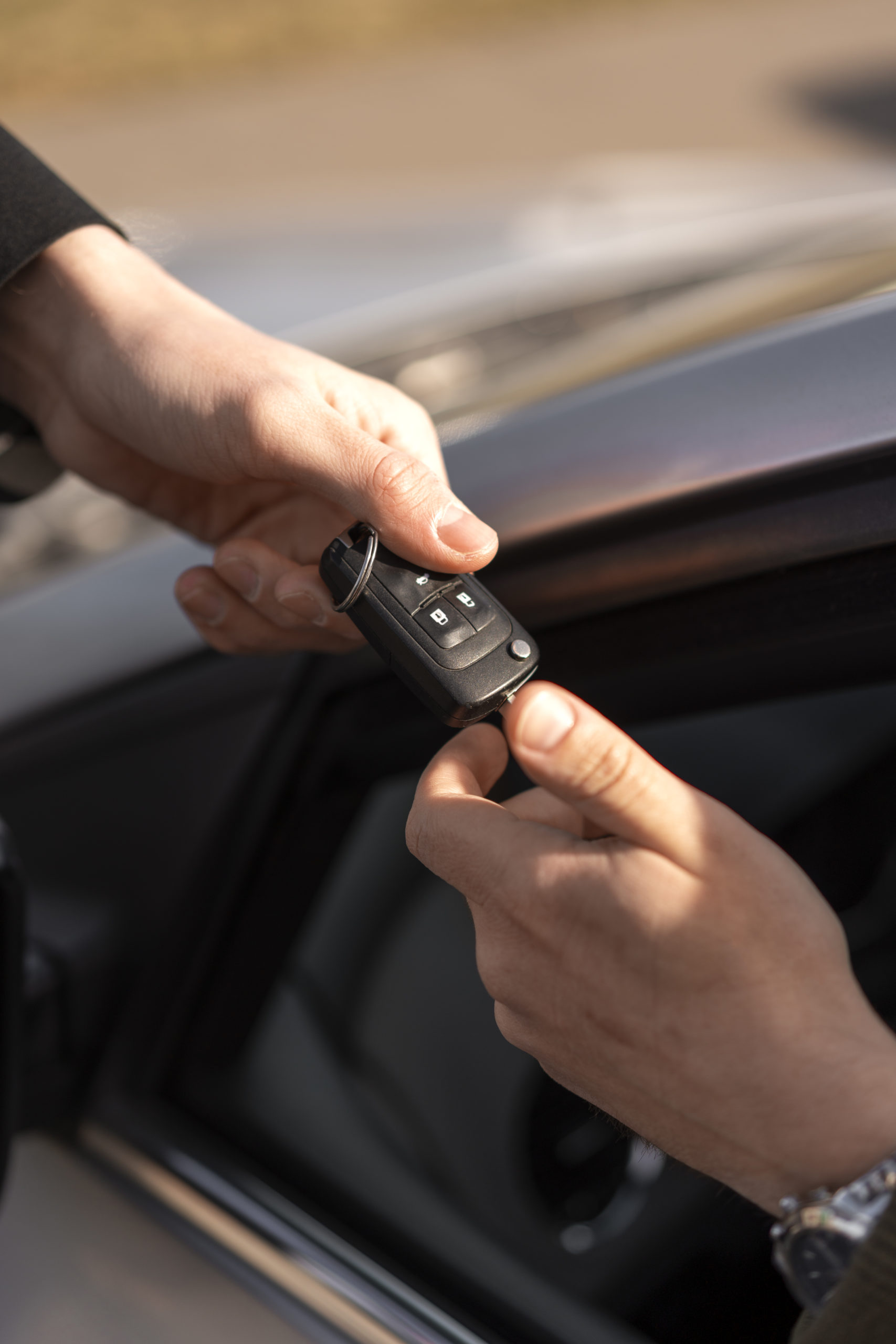 high-angle-hands-holding-car-key